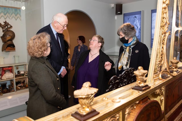 Guests are shown exhibits by Museum director Sue Shave