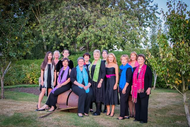 The Adstock Singers, including Emma Shudell, seated with a blue scarf, who passed away last September