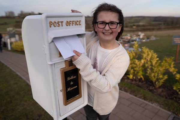 Matilda Handy, 9, with her postbox to heaven, which is coming to Aylesbury. Photo: SWNS