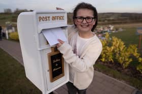 Matilda Handy, 9, with her postbox to heaven, which is coming to Aylesbury. Photo: SWNS