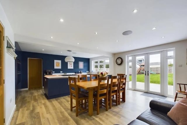 The dining area has French doors that lead out to the rear garden, spotlights to ceiling, Karndean flooring, radiators and space for a large dining table set. Door to the family room.