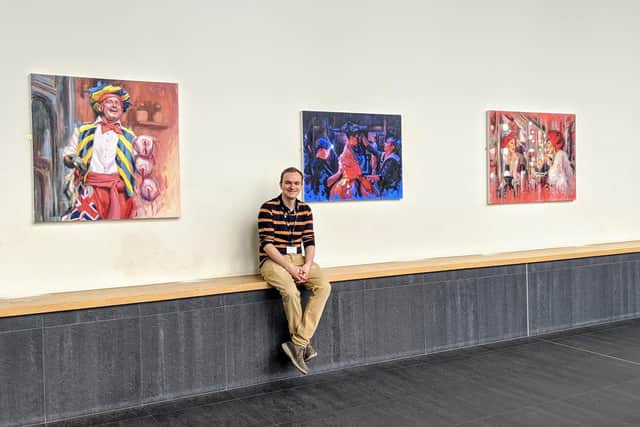 Aylesbury Waterside Theatre residential artist Peter Keegan in front of his paintings
