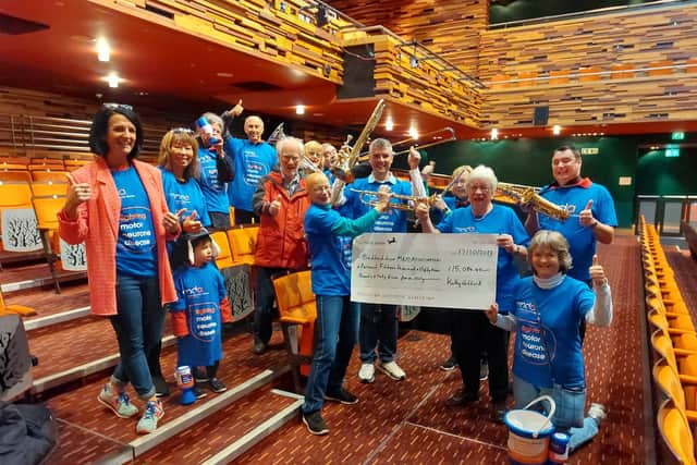 Rita Beaumont, lead volunteer for the Bedfordshire group of the MNDA accepting the large cheque for £15,008.45 donated following Nick Care’s BIG Band Paean. The cheque is presented to Rita by the concert’s producer Kathy Gifford, together with members of the audience, volunteers and players, and Waterside theatre events manager Julie Chitty.