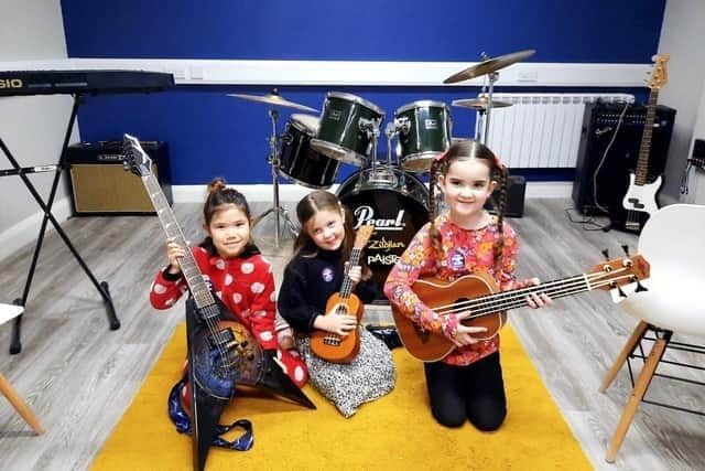 Children learning to play guitar during Learn to Play