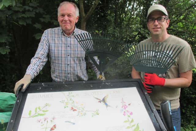 Members of the Scotts Lane Conservation Group with one of their hand-painted information boards