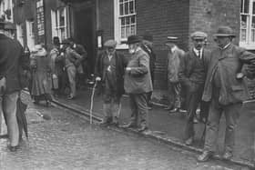 A group of farmers discuss the insurance protest meeting they have just attended in Aylesbury on 10th August 1912.