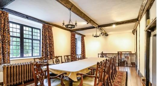 A long dining hall which can comfortably seat a dozen guests.