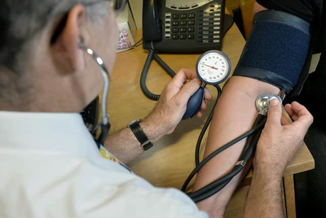 File photo dated 29/07/24 of a doctor checking a patient's blood pressure. Photo from (Anthony Devlin/ PA Images)