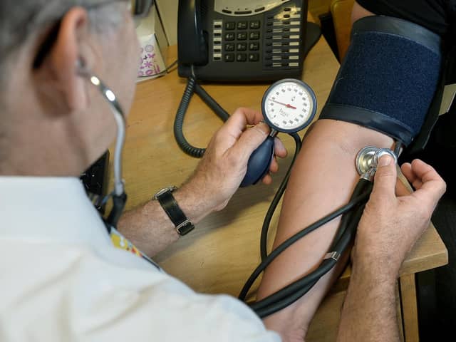 File photo dated 29/07/24 of a doctor checking a patient's blood pressure. Photo from (Anthony Devlin/ PA Images)
