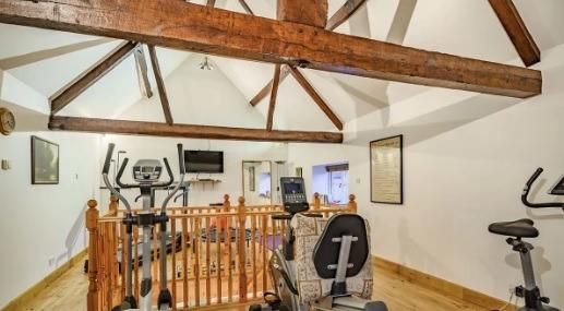 The upstairs home gym that the current occupants set up at the property.