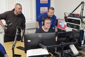 Presenters gather round the studio during a live broadcast
