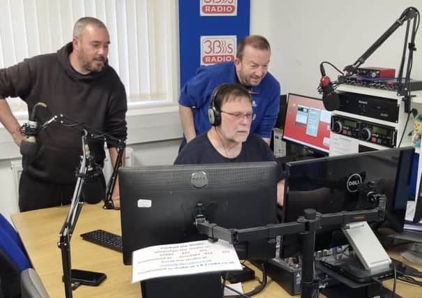 Presenters gather round the studio during a live broadcast