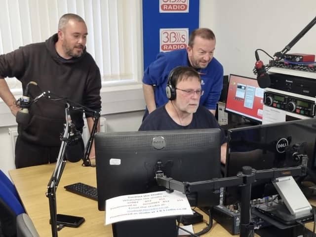 Presenters gather round the studio during a live broadcast