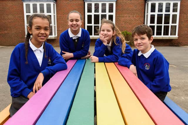 Pupils at Steeple Claydon Primary School enjoy their new rainbow bench (Photo: Richard Eaton)