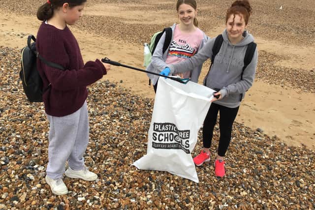 Members of the school's HOPE team completing a beach clean task