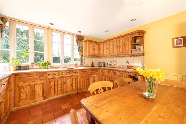 The property includes a farmhouse style kitchen and breakfast room, with a table that has room to seat six people