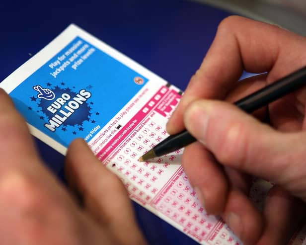 Filling out a lottery ticket.