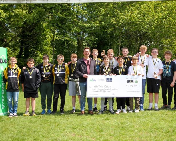 TringRugby U13s present a cheque to Robert Stringer of Hectors House