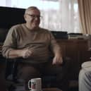 Volunteer Liam (left) with blind veteran Ken enjoying a cup of tea and a chat