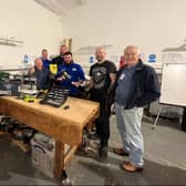 Workshop members examine the new tools