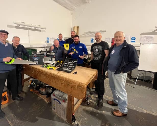 Workshop members examine the new tools