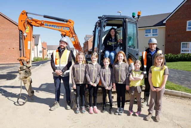 The Brownies with St Rumbold's Fields site managers and a digger 