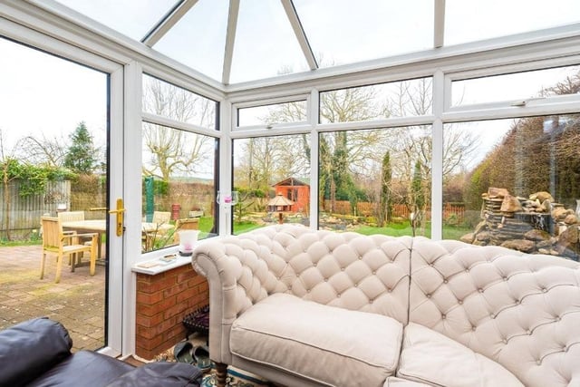 The relaxing conservatory overlooks the picturesque private garden.