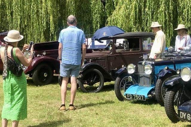 Vintage cars displayed around the gardens and lakes of Adwell House