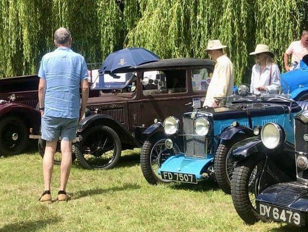 Vintage cars displayed around the gardens and lakes of Adwell House