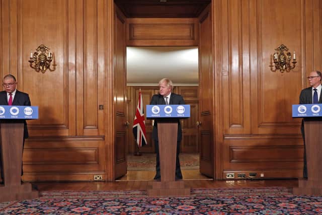 Deputy Chief Medical Officer for England Jonathan Van Tam (left), Prime Minister Boris Johnson (centre) and National Medical Director of NHS England Professor Stephen Powis (right) speaking at a press conference in 10 Downing Street. (photo from Heathcliff O'Malley/Daily Telegraph/ PA Images)