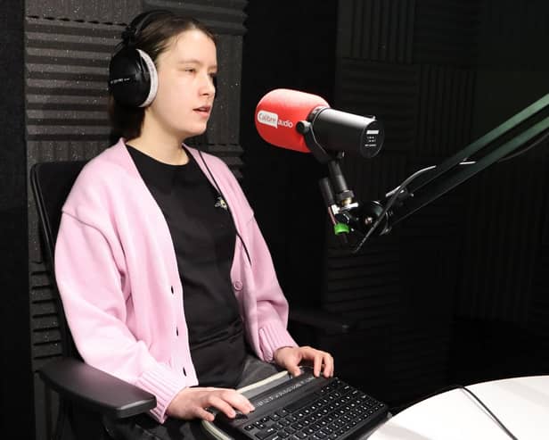 Actress Ellie Wallwork records the announcement of the winners using her Braille reader