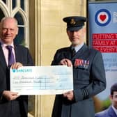 Wing Commander Piers Morrell, Principal Director of Music, Royal Air Force, receives £5,000 raised at last year's concert from Prof Nick Braisby, vice-chancellor of Bucks New University