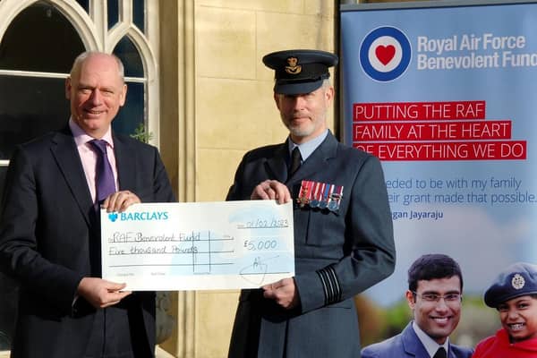 Wing Commander Piers Morrell, Principal Director of Music, Royal Air Force, receives £5,000 raised at last year's concert from Prof Nick Braisby, vice-chancellor of Bucks New University