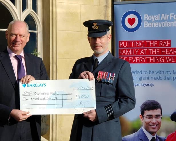 Wing Commander Piers Morrell, Principal Director of Music, Royal Air Force, receives £5,000 raised at last year's concert from Prof Nick Braisby, vice-chancellor of Bucks New University