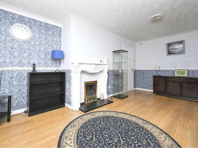 The front lounge is the largest room in the bungalow. It is a cosy space with a feature fireplace.