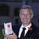 Adam Hills after being made a MBE (Photo by Andrew Matthews - Pool/Getty Images)