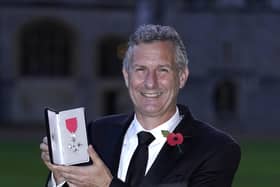 Adam Hills after being made a MBE (Photo by Andrew Matthews - Pool/Getty Images)