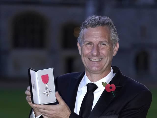 Adam Hills after being made a MBE (Photo by Andrew Matthews - Pool/Getty Images)