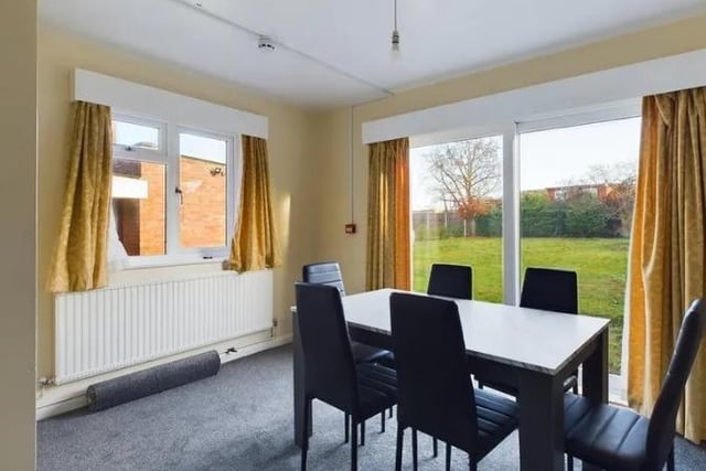 The dining room consists of sliding doors to the garden, a carpet laid to floor, light fitting to ceiling, radiator and space for a dining table set