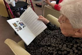 A Fremantle Trust resident reading their newly published book.