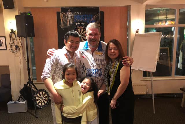 The Wong family with former darts star Martin Adams