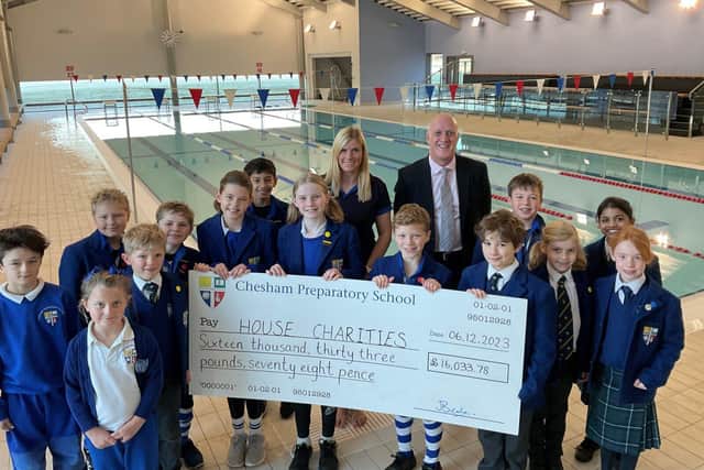 Pupils with Headmaster Mr Beale and Head of Swimming Mrs Shaw at the school swimming pool.