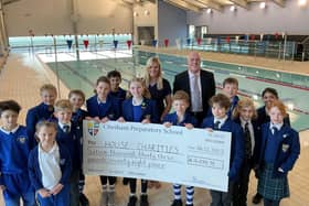 Pupils with Headmaster Mr Beale and Head of Swimming Mrs Shaw at the school swimming pool.