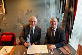 Anthony (left) and Paul signing the agreement.
