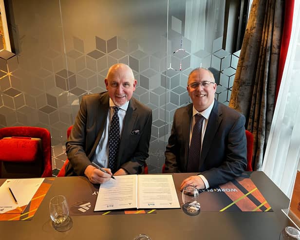 Anthony (left) and Paul signing the agreement.