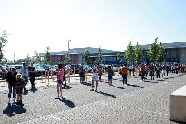 Shoppers in Milton Keynes wait to enter a Primark store at the MK1 Shopping Park.