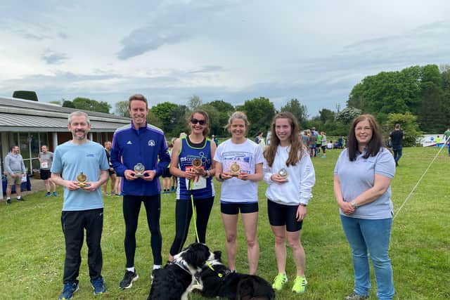 Kieran White (men’s winner), Adam Shute, Hannah Rogan, Jessica Downs (women’s winner) and Fiona Kelleher being presented their trophies by Jen Beaujeux from BWK Solicitors, the race sponsor.