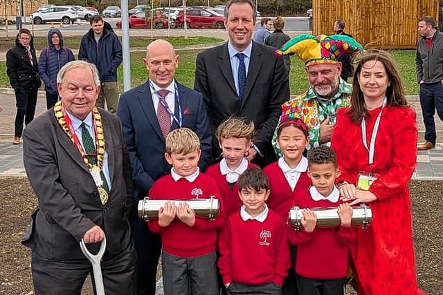 Burying the time capsules - from left John Chilver, chairman of Buckinghamshire Council, Jon Mason, chief executive of Inspiring Futures Partnership Trust, Carl Jackson, cabinet member for education and children's services, Andy Collins (Lester the Jester), and Liz Jones, head of Orchard View Primary Academy