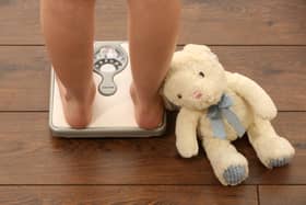 Picture posed by model. An 11 year old girl using a set of weighing scales. Photo from Chris Radburn/PA Images