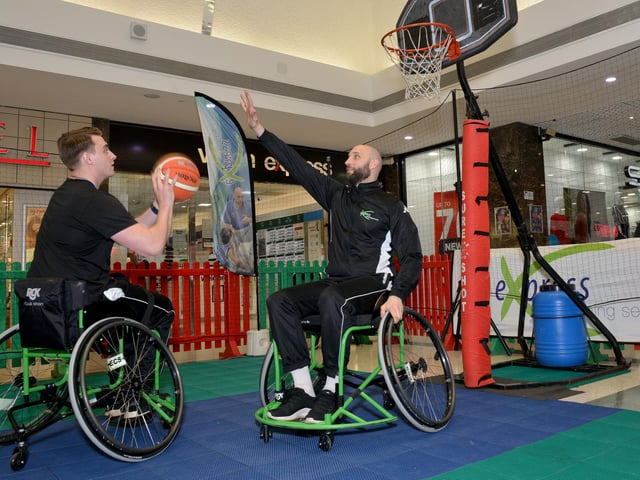 A wheelchair basketball demonstration takes place at the Four Seasons Shopping Centre.